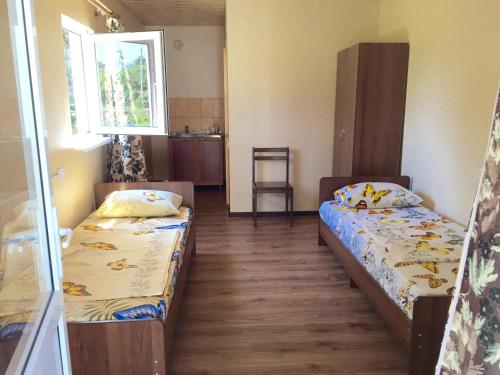 a room with two beds and a window at Guest house Y morya in Sukhum