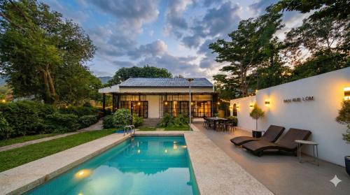 a house with a swimming pool in the backyard at Ban Rub Lom Pool Villa 3 difference villas in Rayong
