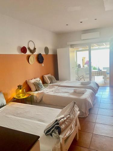 a hotel room with two beds and a balcony at Blue Peter Apartments in Protaras