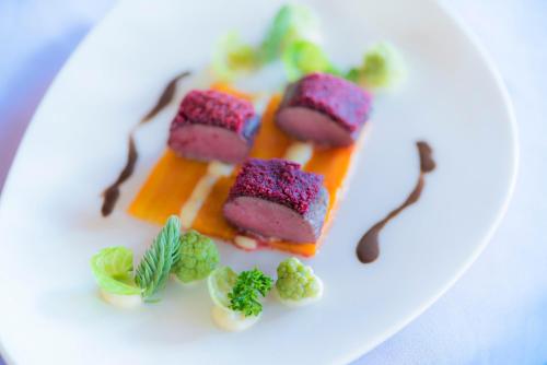 a white plate with three different types of food at Caschu Alp Boutique Design Hotel Stoos - adults only in Stoos