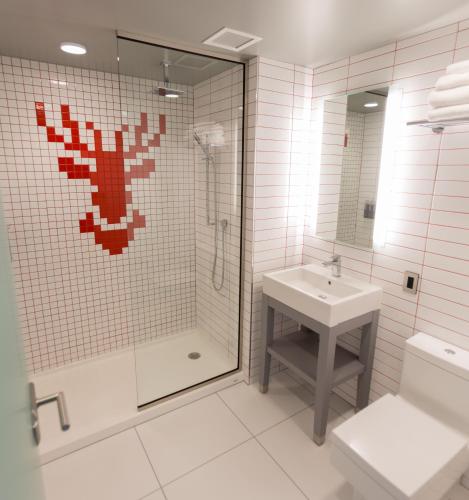 a bathroom with a shower and a toilet and a sink at Radisson Red Minneapolis Downtown in Minneapolis