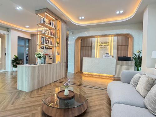 a living room with a couch and a table at Indigo Hotel Hatyai 2 Khet 8 in Sathani Hat Yai