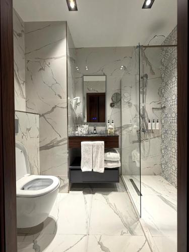 a bathroom with a toilet and a shower at Surxondaryo Hotel Tashkent in Teshabayguzar