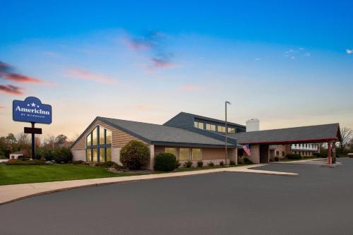 a building with a sign in front of it at AmericInn by Wyndham Green Bay West in Green Bay