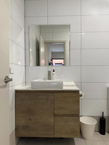 a bathroom with a sink and a mirror at Gallery Boutique Hotel in Fremantle