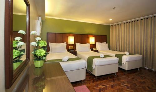 Ένα ή περισσότερα κρεβάτια σε δωμάτιο στο The Corporate Inn Hotel