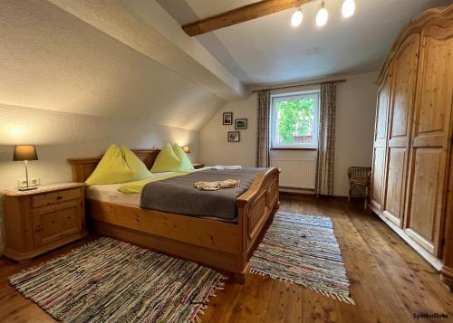 a bedroom with a large bed and a window at Bio-Bauernhof Simonbauer in Ramsau am Dachstein