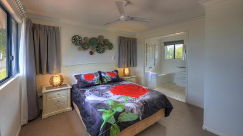a bedroom with a bed and a bathroom at Dolphin Waters in Tin Can Bay