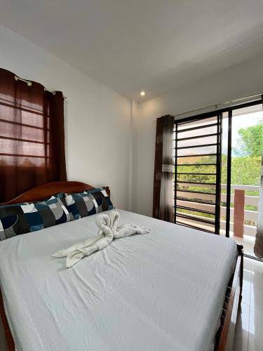 a bedroom with a bed with a white towel on it at Villareal Homestay in Coron