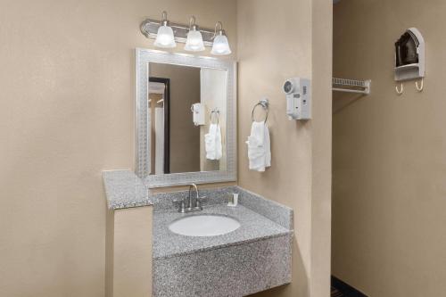 a bathroom with a sink and a mirror at Super 8 by Wyndham Casa Grande in Casa Grande