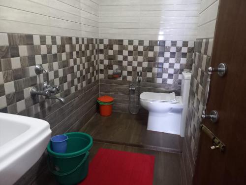 a bathroom with a toilet and a sink and a shower at The Seaview Residency in Port Blair