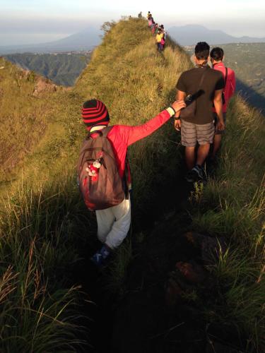 a group of people walking on a hill at Rumah Dadong in Ubud