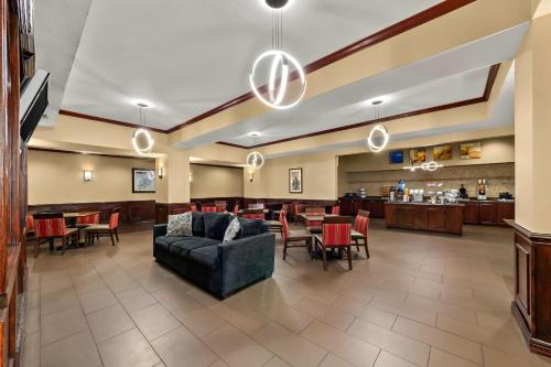 a lobby with a couch and chairs and a bar at Comfort Suites Corpus Christi Central in Corpus Christi