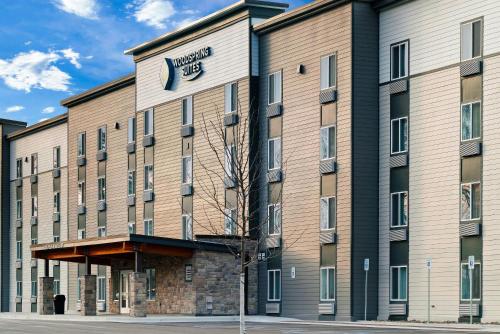 a rendering of the front of a hotel at WoodSpring Suites East Lansing - University Area in East Lansing
