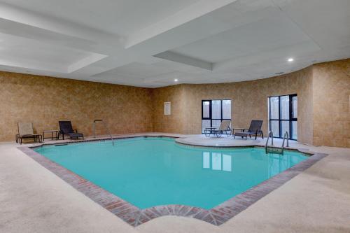 a large pool in a hotel room with blue water at Wyndham Lake Charles in Lake Charles