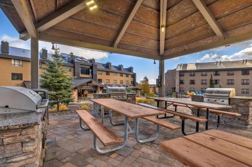 a patio with picnic tables and a grill at Hilton Vacation Club Cedar Breaks Brian Head in Brian Head