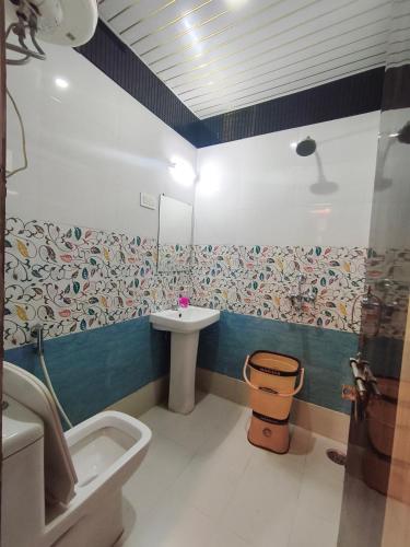 a bathroom with a sink and a toilet at Hotel Gulmohar in Haridwār