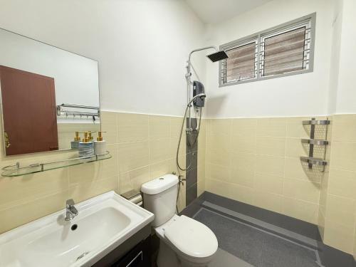 a bathroom with a toilet and a sink at R3troHouse3 4BR 14PAX Near188Tower, HTAA, In Town in Kuantan