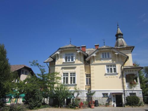 a large house with a tower on top of it at Guest House Veronika in Kočevje