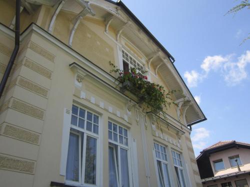 a building with a window with a flower box on it at Guest House Veronika in Kočevje