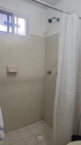 a bathroom with a shower with a shower curtain at Casita Puerto Maya in Puerto Aventuras