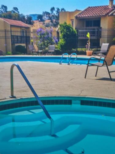 a swimming pool with a chair next to a swimming pool at Departamento completo en San Diego & Bonita You can ask for 30 or more days book and save aditional 15 percent in San Diego
