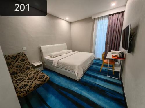 a bedroom with a bed and a tv in it at Love Inn Hotel Kuchai Lama in Kuala Lumpur