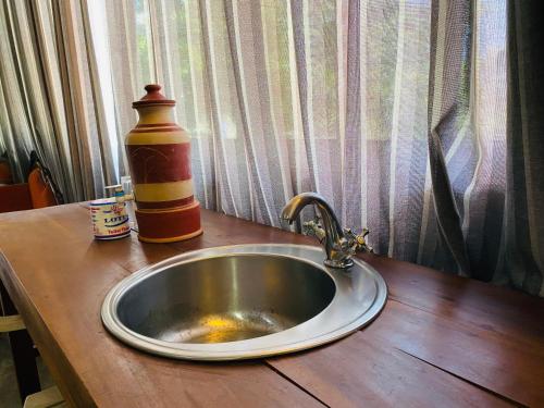a kitchen sink with a bottle and a ketchup at Amadio Beach Resort in Hikkaduwa