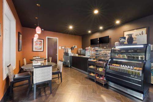 a fast food restaurant with a counter and a bakery at Clarion Inn & Suites Across From Universal Orlando Resort in Orlando