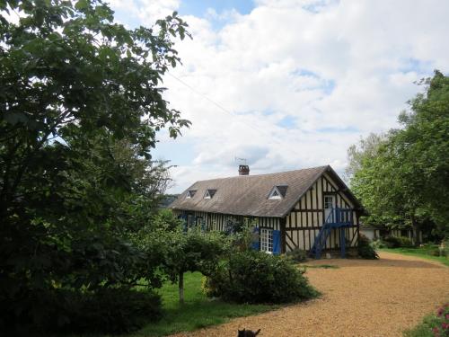 a black and white house with a dog in front of it at Le Chant Des Fees in Notre-Dame-de-Courson