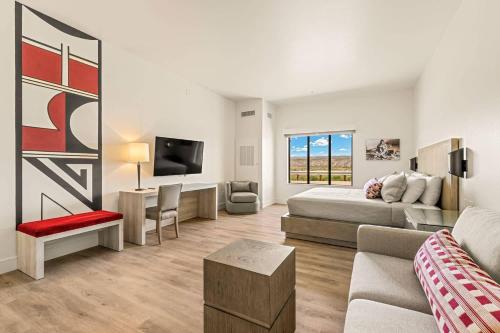 a living room with a bed and a couch at Taawaki Inn - Cottonwood, an Ascend Collection Hotel in Clarkdale
