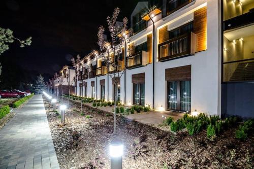 a row of street lights in front of a building at Kolumna Park Hotel in Dobroń
