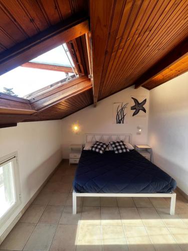 a bedroom with a bed in a room with skylights at Terrazza Belvedere Sanremo in Sanremo