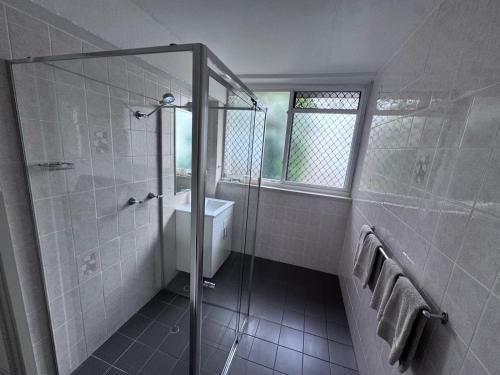 a bathroom with a shower and a sink at Citigate Motel Newcastle in Newcastle