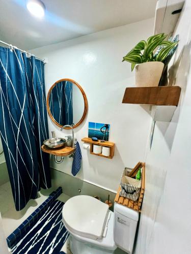 a bathroom with a toilet and a mirror at Kasa Gigi in El Nido
