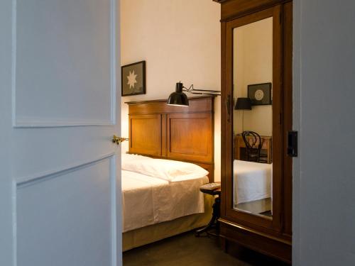 Postel nebo postele na pokoji v ubytování Palazzo Melfi