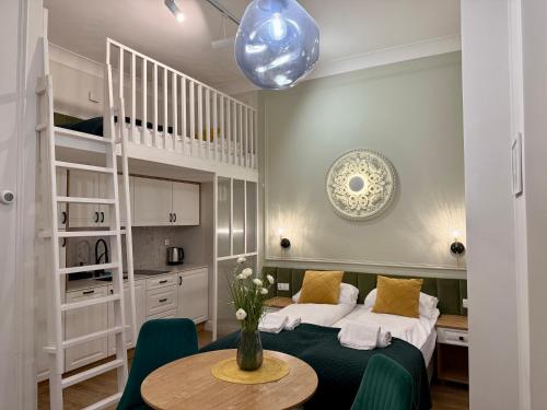 a bedroom with a bed and a table with a vase on it at Apartamenty Katarzynki by Rentoom in Toruń