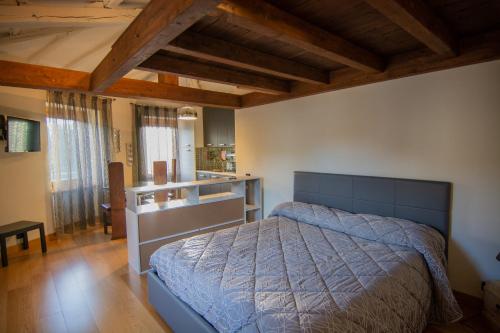a bedroom with a bed in a room with wooden ceilings at Bed and Breakfast La Panarda in Subiaco