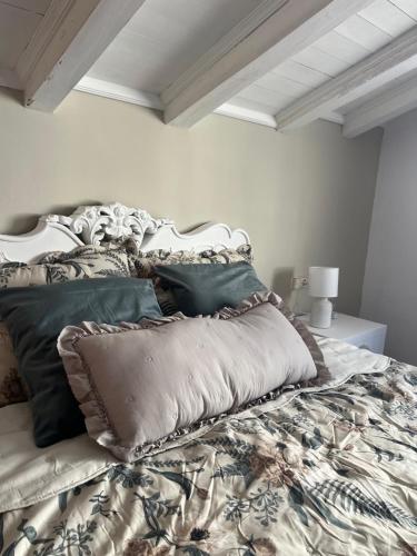 a bed with pillows on it in a bedroom at Séjour Royal in Xàtiva
