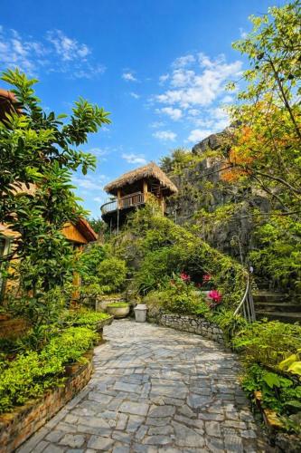 a stone path leading to a house on a hill at Trang An ViewPoint Homestay in Ninh Binh