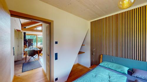 a bedroom with a blue bed and a dining room at Villa SEE la vie in Rheinsberg