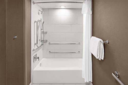 a white bathroom with a tub and a shower at DoubleTree by Hilton Springfield in Springfield