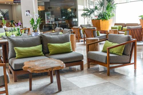 a store with chairs and a couch and a table at Hilton Garden Inn Veracruz Boca del Rio in Veracruz