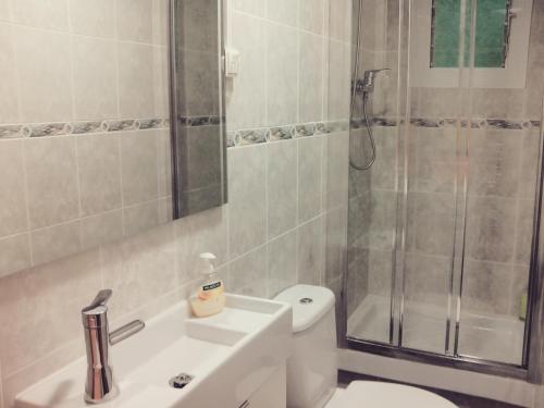 a bathroom with a shower and a toilet and a sink at bcn4days Apartments in Hospitalet de Llobregat