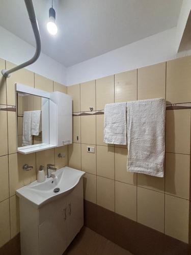 a bathroom with a sink and a mirror and towels at Gem Guest House in Lazarat
