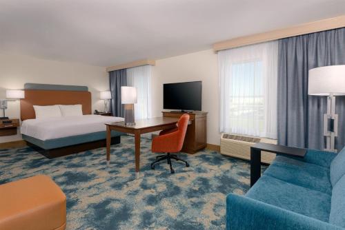 a hotel room with a bed and a desk at Hampton Inn & Suites Tampa Airport Avion Park Westshore in Tampa