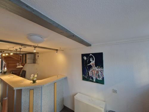 a kitchen with a painting on the wall at Hotel Beere in Salzwedel