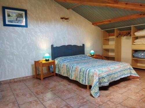 a bedroom with a bed in a room with shelves at Gîte Le Provençal in Vagnas