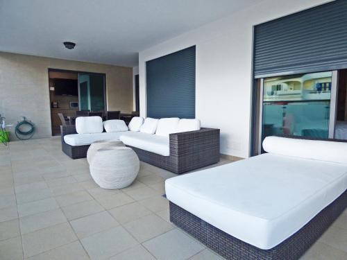 a living room with two couches and a table at Apartamento Olhos D'Água in Albufeira