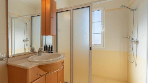 a bathroom with a sink and a shower at Casa Del Sol by LovelyStay in Relógio do Poiso